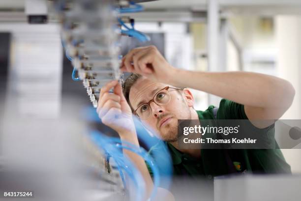 Adjustments on the stringer, a machine that brazes the single solar cells together in a chain, are being made on August 01, 2017 in Frankfurt an der...