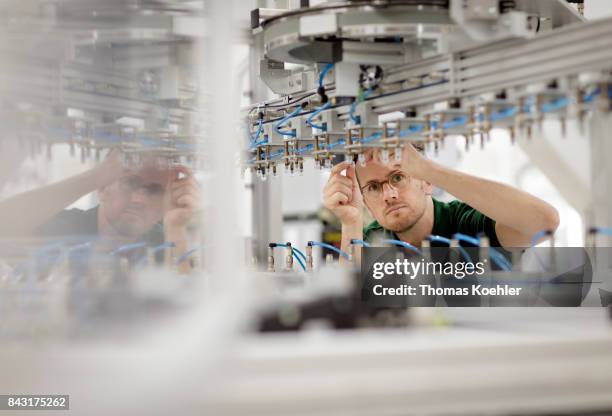 Adjustments on the stringer, a machine that brazes the singlesolar cells together in a chain, are being made on August 01, 2017 in Frankfurt an der...