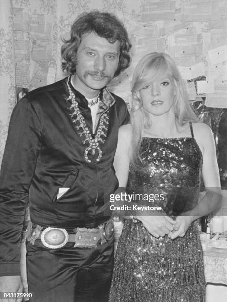 French singer Johnny Hallyday comes to congratulate his wife, singer and actress Sylvie Vartan, after her performance at the Olympia music hall in...