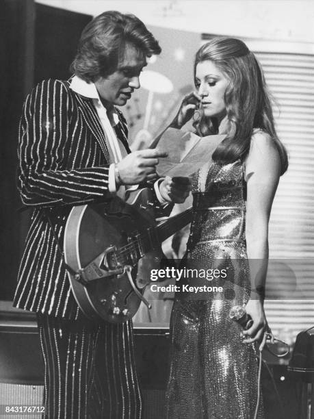 French singers Johnny Hallyday and Sheila perform a duet on a television show being filmed at the Golf-Drouot nightclub in Paris, France, 13th...
