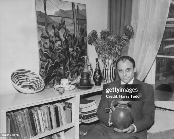 Czech-born British actor and collector of antiques Herbert Lom holding an Etruscan jug from the 5th century BC at his flat in Kensington, London,...