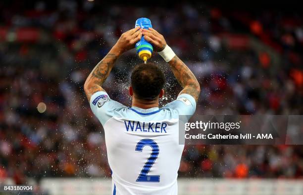 Kylde Walker of England sprays water over his head during the FIFA 2018 World Cup Qualifier between England and Slovakia at Wembley Stadium on...