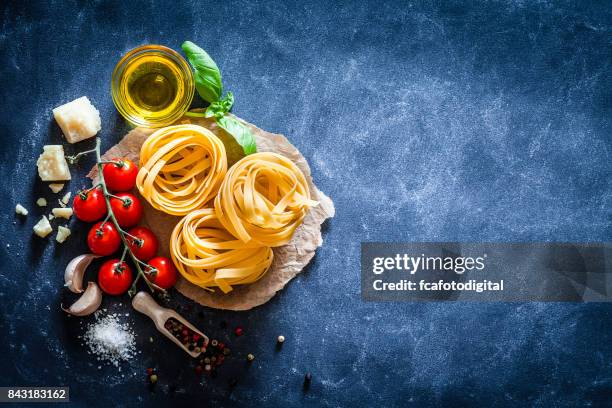 tagliatelle with ingredients on dark table - tagliatelle stock pictures, royalty-free photos & images