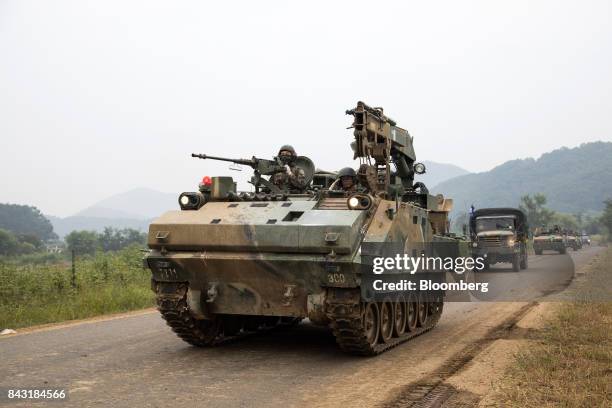 South Korean army combat engineer vehicle, front, and truck, behind, travel along a road near the border in Paju, South Korea, on Wednesday, Sept. 6,...