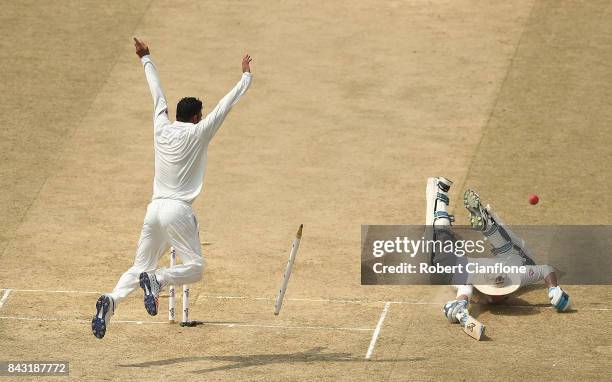 Peter Handscomb of Australia is run out by a throw from Shakib Al Hasan of Bangladesh during day three of the Second Test match between Bangladesh...