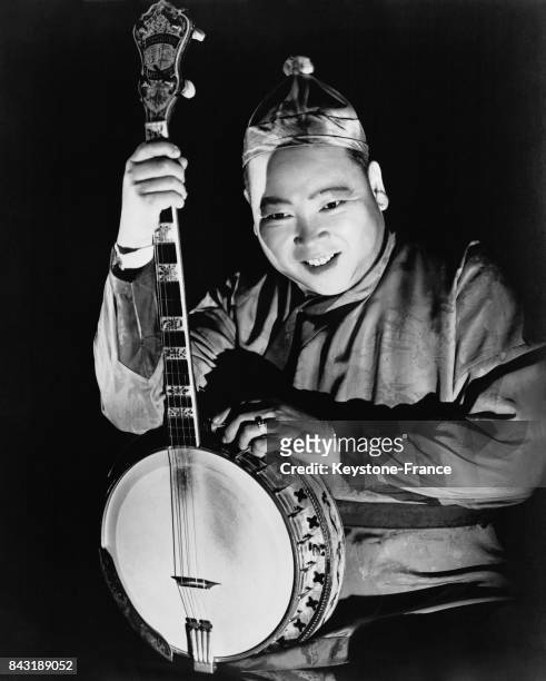 Le musicien et pantomime chinois Prince Gum Low se produit avec son banjo.