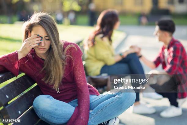 attractive woman crying in the park and ignoring one happy couple - red eyes stock pictures, royalty-free photos & images