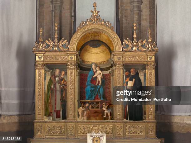 Italy, Veneto, Venice, Santa Maria Gloriosa dei Frari Basilica, sacristy. Whole artwork view. Gold frame niche Madonna Virgin Mary Baby Child Jesus...