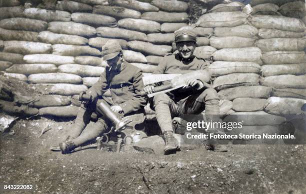 Soldiers with a 58 mortar in a blockhouse protected by a wall of sand bags at Serravalle, Photography, Italy, May 1917.