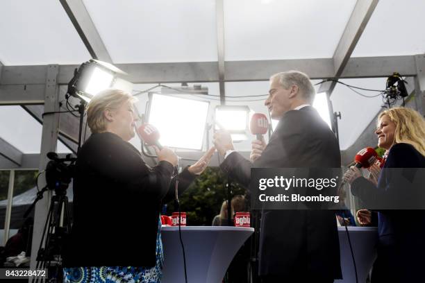 Erna Solberg, Norway's prime minister, left, and Jonas Gahr Store, leader of Norway's Labor Party, gesture to each other as they take part in a...