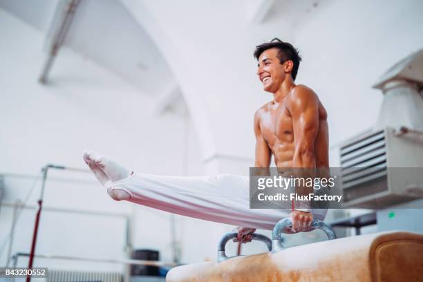 men working out on pommel horse - artistic gymnastics stock pictures, royalty-free photos & images