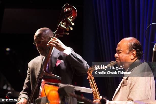 American Jazz musicians Ron Carter , on upright bass, and Benny Golson, on saxophone, perform onstage at the Blue Note nightclub, New York, New York,...