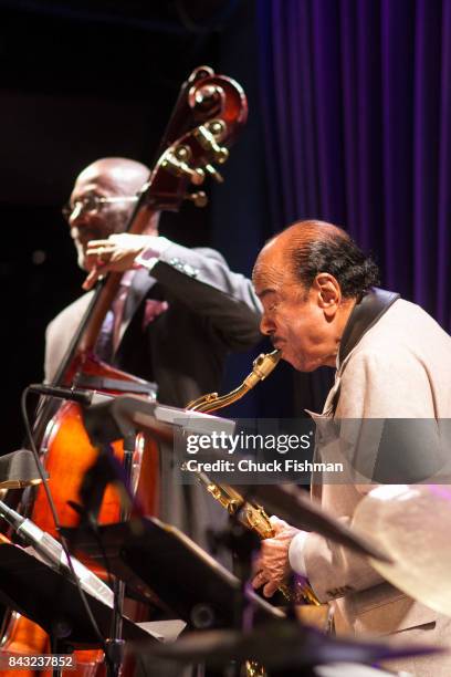 American Jazz musicians Ron Carter , on upright bass, and Benny Golson, on saxophone, perform onstage at the Blue Note nightclub, New York, New York,...