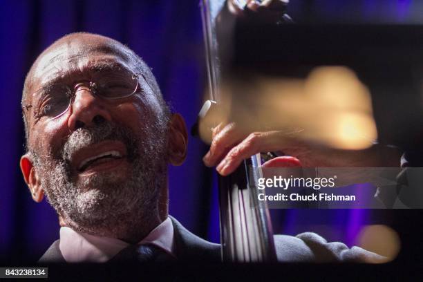 American Jazz musician Ron Carter plays upright bass, as he performs onstage at the Blue Note nightclub, New York, New York, July 13, 2017.