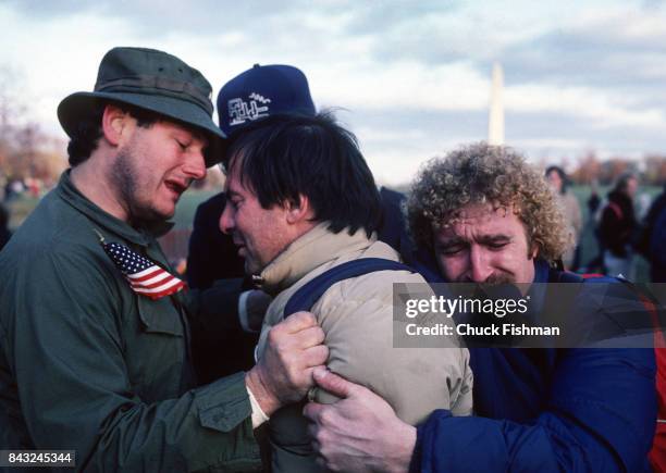 Group of Vietnam veterans embrace after the Vietnam War Memorial dedication, Washington DC, November 13, 1982.