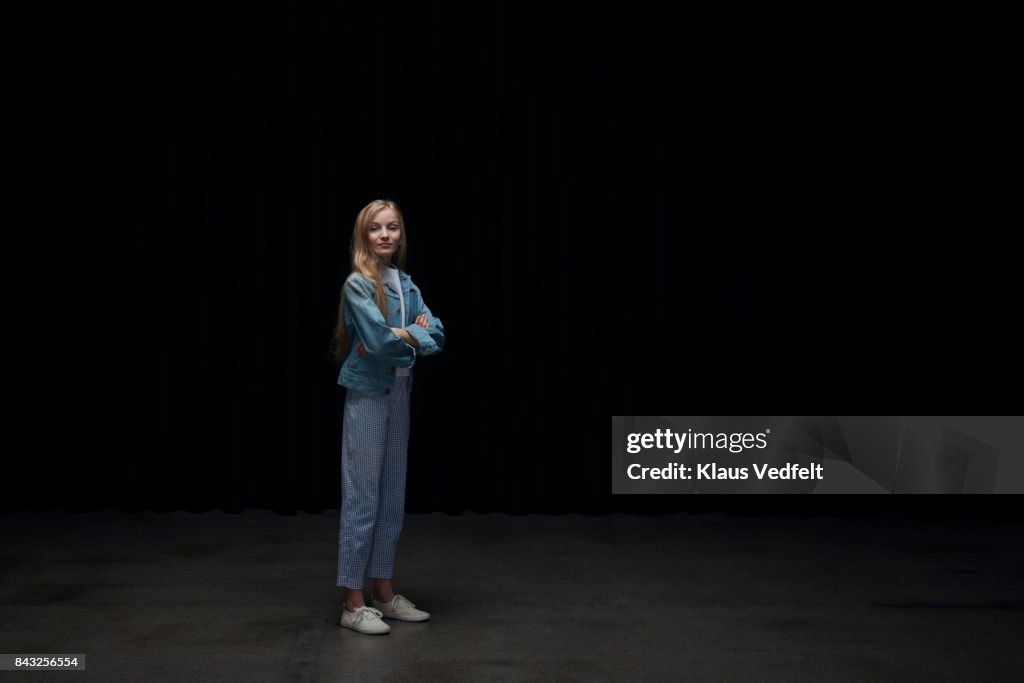 Girl wearing denim jacket, smilling at looking up in camera