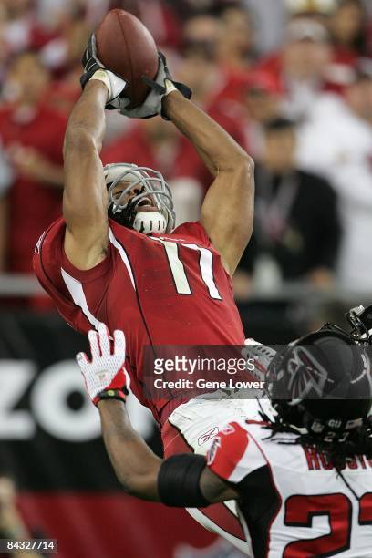 Arizona Cardinals wide receiver Larry Fitzgerald jumps and makes a acrobatic catch for a touchdown during an NFC Wildcard Playoff game against the...