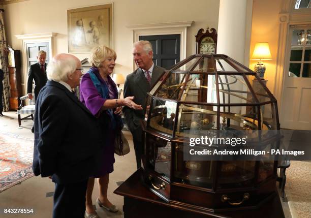 The Prince of Wales, known as the Duke of Rothesay in Scotland, President of Ireland Michael D Higgins and his wife Sabina view the Grand Orrery, an...