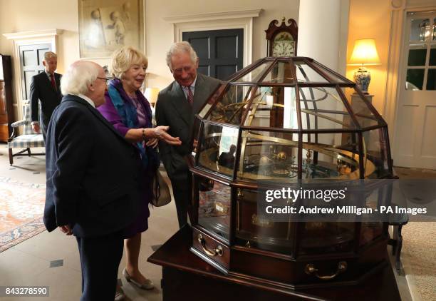 The Prince of Wales, known as the Duke of Rothesay in Scotland, President of Ireland Michael D Higgins and his wife Sabina view the Grand Orrery, an...