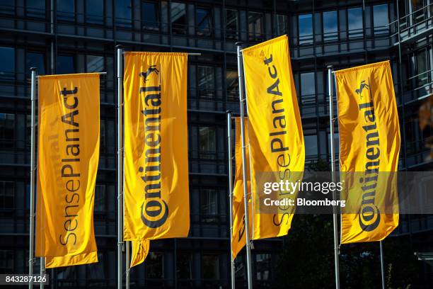 The Continental AG logo sits on flags flying outside the company's offices following the presentation of the Cube autonomous robo-taxi in Frankfurt,...
