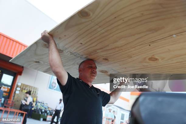 Pedro Toledo purchases plywood at The Home Depot as he prepares for Hurricane Irma on September 6, 2017 in Miami, Florida. It's still too early to...