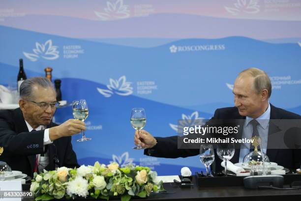 Russian President Vladimir Putin toasts with Taisei Corporation CEO Takashi Yamauchi during the dinner for foreign businessmen on September 6, 2017...