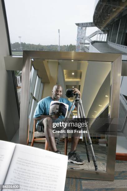 Self Portrait of Jacksonville Jaguars Marcellus Wiley casual with book and camera at Alltel Stadium. Jacksonville, FL CREDIT: Bill Frakes