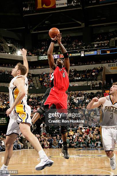 Jermaine O'Neal of the Toronto Raptors shoots over Rasho Nesterovic of the Indiana Pacers at Conseco Fieldhouse on January 16, 2009 in Indianapolis,...