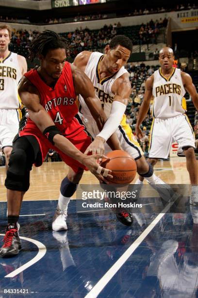 Chris Bosh of the Toronto Raptors battles for the ball with Danny Granger of the Indiana Pacers at Conseco Fieldhouse on January 16, 2009 in...