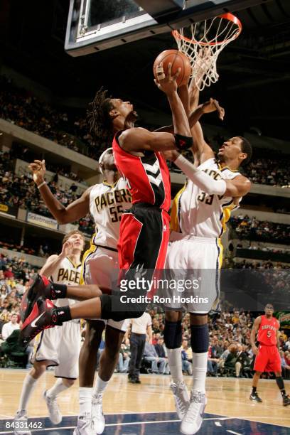 Chris Bosh of the Toronto Raptors drives against Danny Granger of the Indiana Pacers at Conseco Fieldhouse on January 16, 2009 in Indianapolis,...