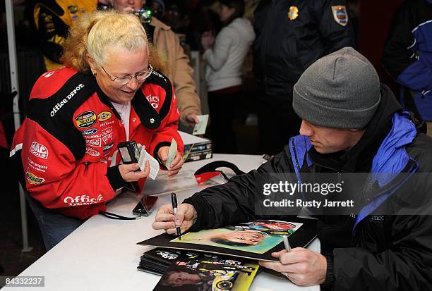 Carl Edwards, driver of the Aflac Ford signs autographs for the fans during NASCAR Preseason Thunder at Daytona International Speedway on January 16,...