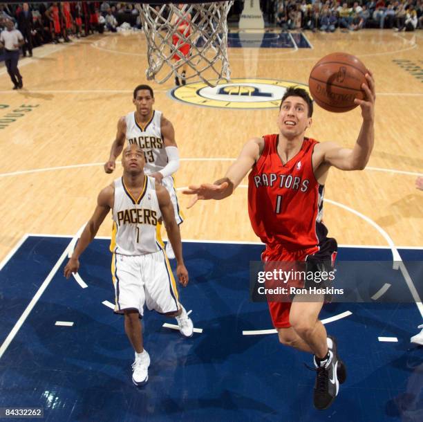 Roko Ukic of the Toronto Raptors lays the ball up over Jarrett Jack of the Indiana Pacers at Conseco Fieldhouse on January 16, 2009 in Indianapolis,...