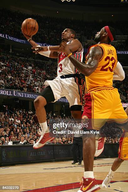 Chris Paul of the New Orleans Hornets glides in for the shot against LeBron James of the Cleveland Cavaliers at The Quicken Loans Arena on January...