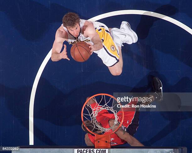 Troy Murphy of the Indiana Pacers shoots over a Toronto Raptors defender at Conseco Fieldhouse on January 16, 2009 in Indianapolis, Indiana. The...