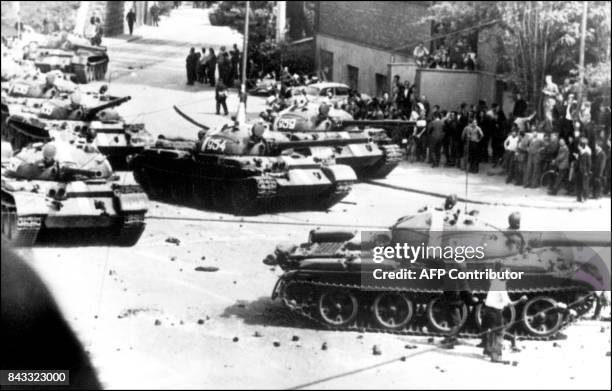 Prague residents shown in a file photo dated 21 August 1968 throwing stones at Soviet tanks entering Prague during confrontations between...