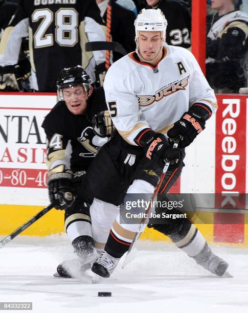 Chris Pronger of the Anaheim Ducks moves the puck in front of Matt Cooke of the Pittsburgh Penguins on January 16, 2009 at Mellon Arena in...