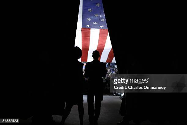 Democratic presidential candidate U.S Senator Barack Obama of Illinois and his wife Michelle Obama walk out from behind a curtain to greet the...