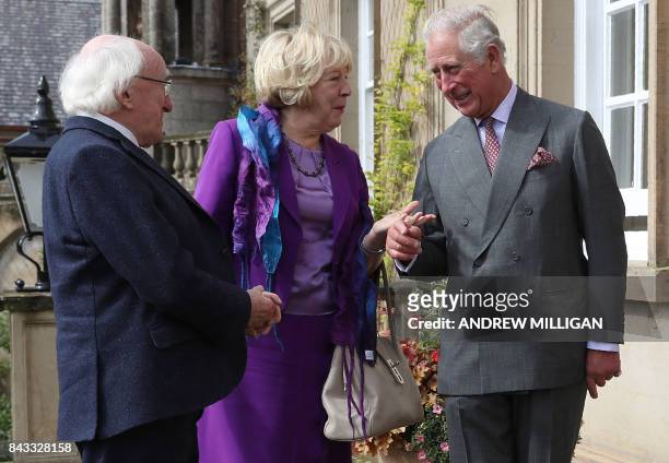 Britain's Prince Charles, Prince of Wales greets Ireland's President Michael D Higgins , and his wife Sabina Higgins, as they arrive at Dumfries...