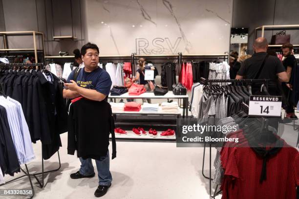 Shopper browses clothing items on display at London's first Reserved store, operated by LPP SA, during its opening day on Oxford Street in central...