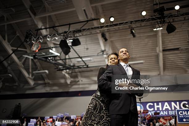 Democratic presidential hopeful U.S Senator Barack Obama and his wife Michelle Obama take the stage at a primary night rally in the gymnasium at the...