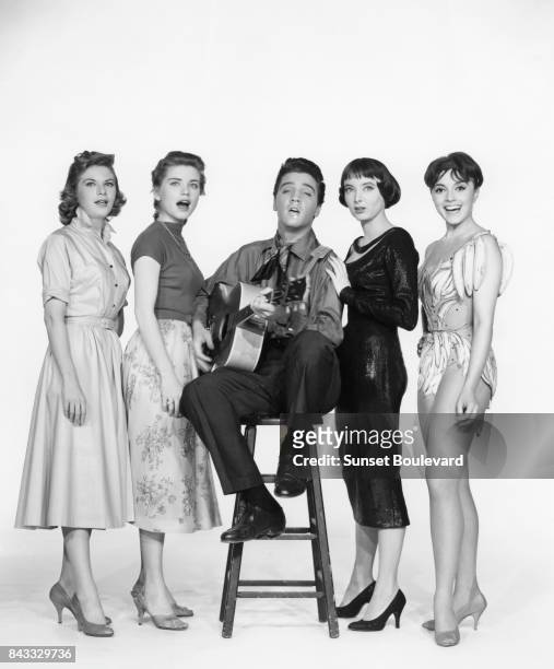 American singer, actor Elvis Presley surrounded by actresses Jan Shepard, Dolores Hart, Carolyn Jones and French actress Liliane Montevecchi on the...