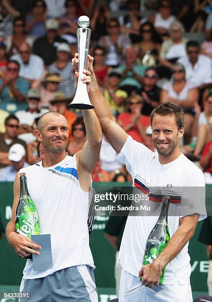 Martin Damm of Czech Republic and Robert Lindstedt of Sweden hold the trophy after winning the doubles final match against Scott Lipsky of USA and...