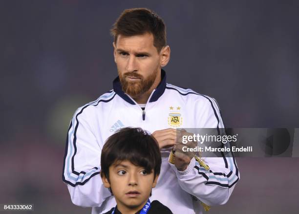 Lionel Messi of Argentina stands next to Benjamin Aguero Maradona during the national anthem ceremony ahead of match between Argentina and Venezuela...