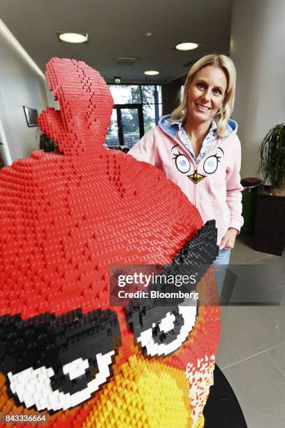 Kati Levoranta, chief executive officer of Rovio Entertainment Oy, poses for a photograph with a model of Angry Birds character 'Red' in the...