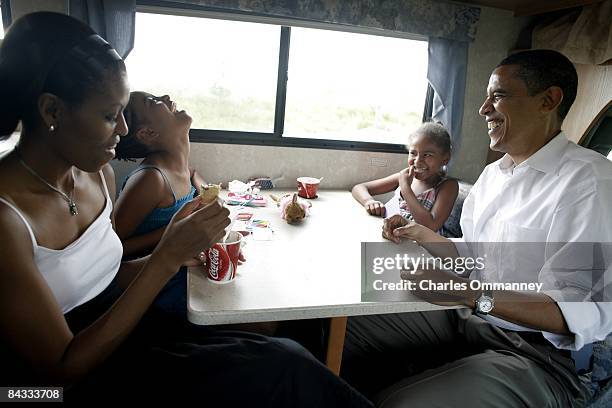 Democratic presidential hopeful U.S. Senator Barack Obama , his wife Michelle and two daughters Sasha and Malia play cards in their RV, July 4, 2007...