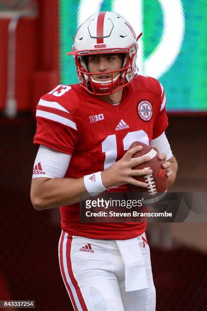 Quarterback Tanner Lee of the Nebraska Cornhuskers warms up before the game against the Arkansas State Red Wolves at Memorial Stadium on September 2,...