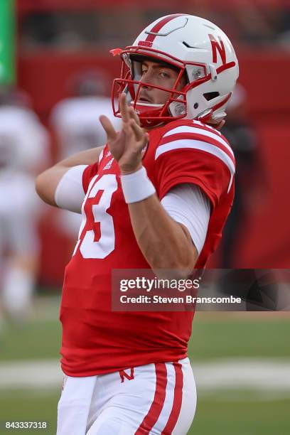 Quarterback Tanner Lee of the Nebraska Cornhuskers warms up before the game against the Arkansas State Red Wolves at Memorial Stadium on September 2,...