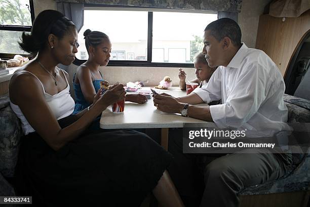 Democratic presidential hopeful U.S. Senator Barack Obama , his wife Michelle and two daughters Sasha and Malia play cards in their RV, July 4, 2007...