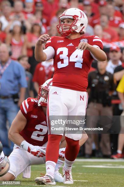 Place kicker Drew Brown of the Nebraska Cornhuskers looks at an extra point attempt against the Arkansas State Red Wolves at Memorial Stadium on...