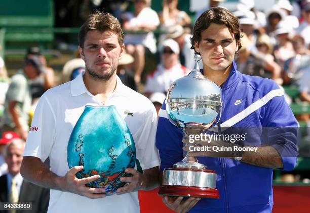 Stanislas Wawrinka and Roger Federer of Switzerland pose with their trophies after the final on day four of the AAMI Classic at the Kooyong Lawn...